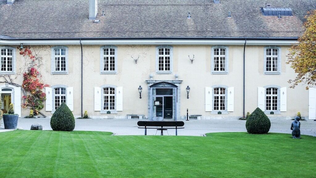 The Château de Bonmont near Geneva, seen across its lawn on an autumn day